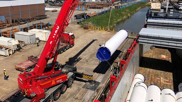 Unloading large steel pipes with a crane at Van Leeuwen in Zwijndrecht.
